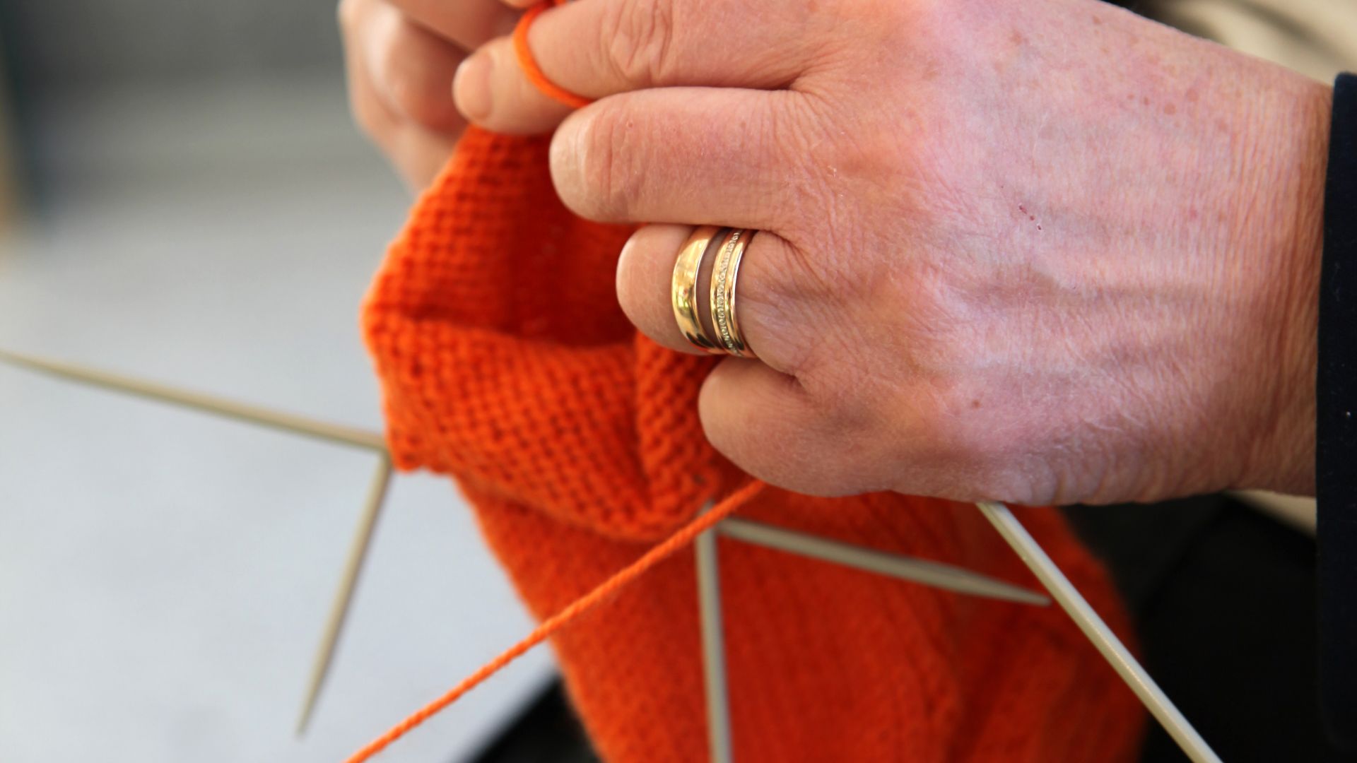 A Hand Wearing Gold Ring Doing Crochet in Close-up Photography