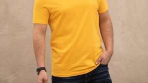 A Man in Yellow Shirt Holding Black Sunglasses