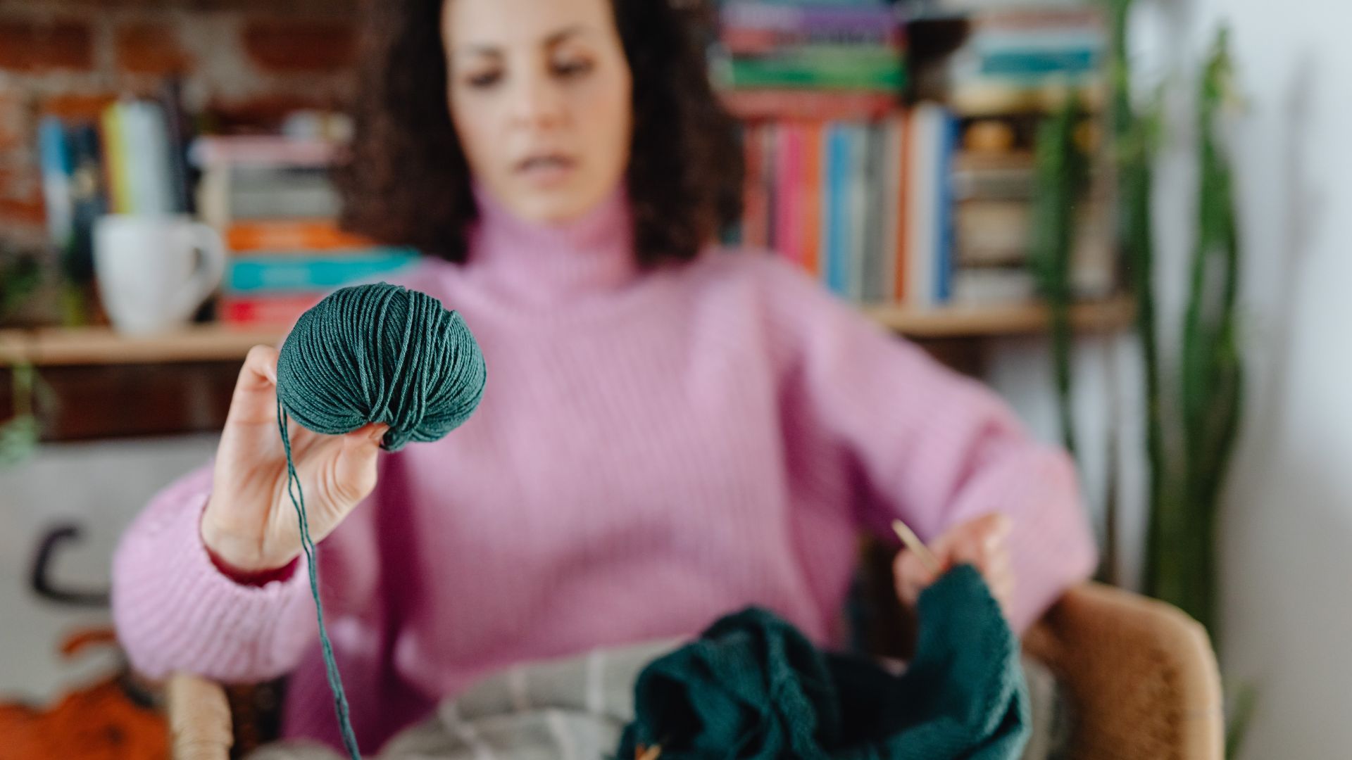 A Woman Holding a Green Yarn