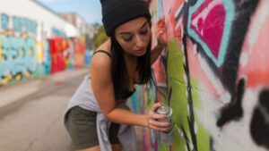 Alluring Woman holding a Can of Spray Paint