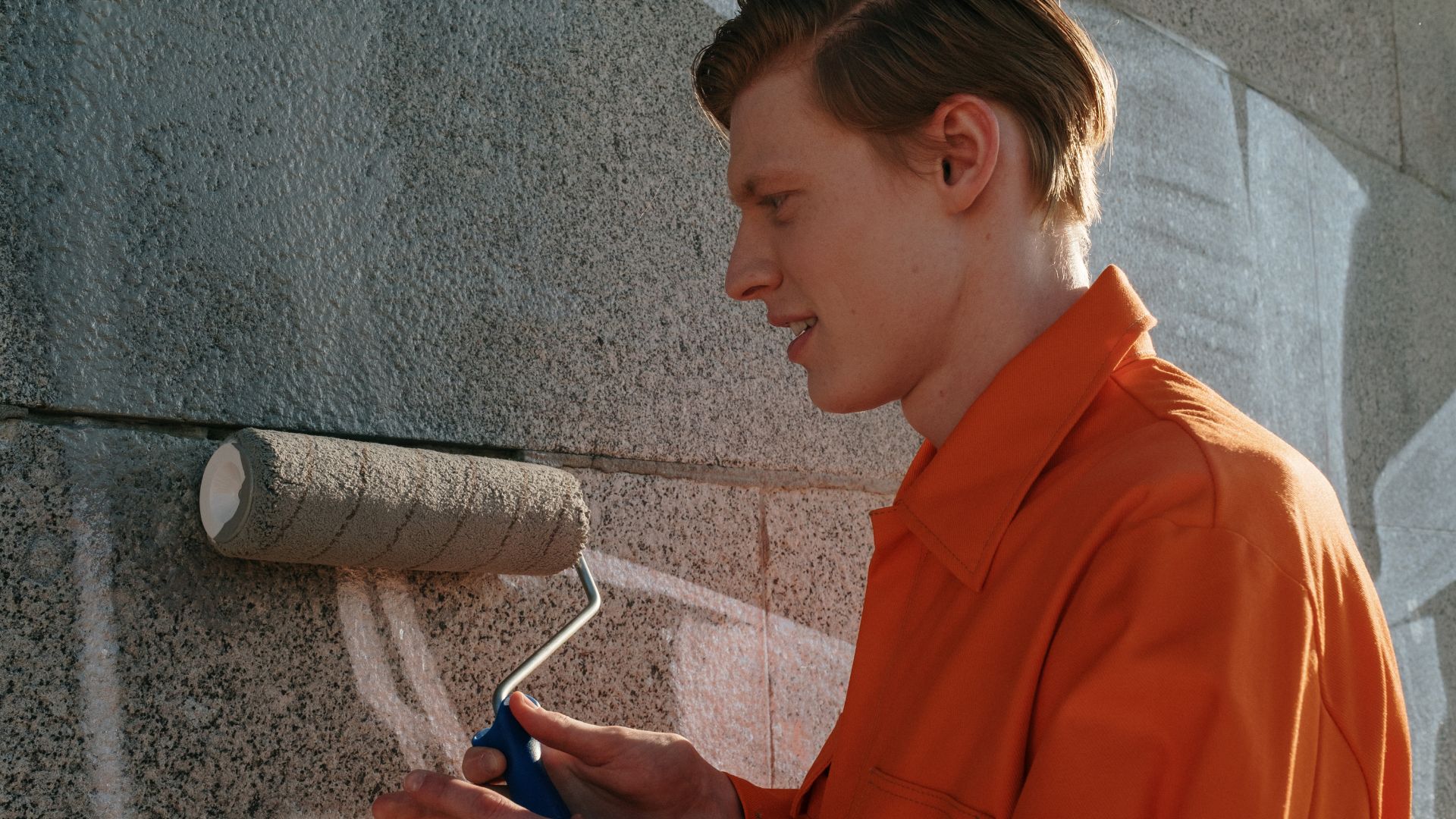 An Inmate Painting over a Gray Wall ,