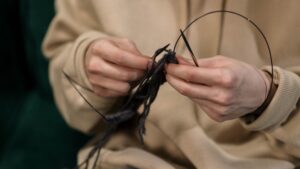 Close-Up Photo of a Person's Hands Knitting