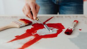 Close-up of an Artist Painting on Canvas