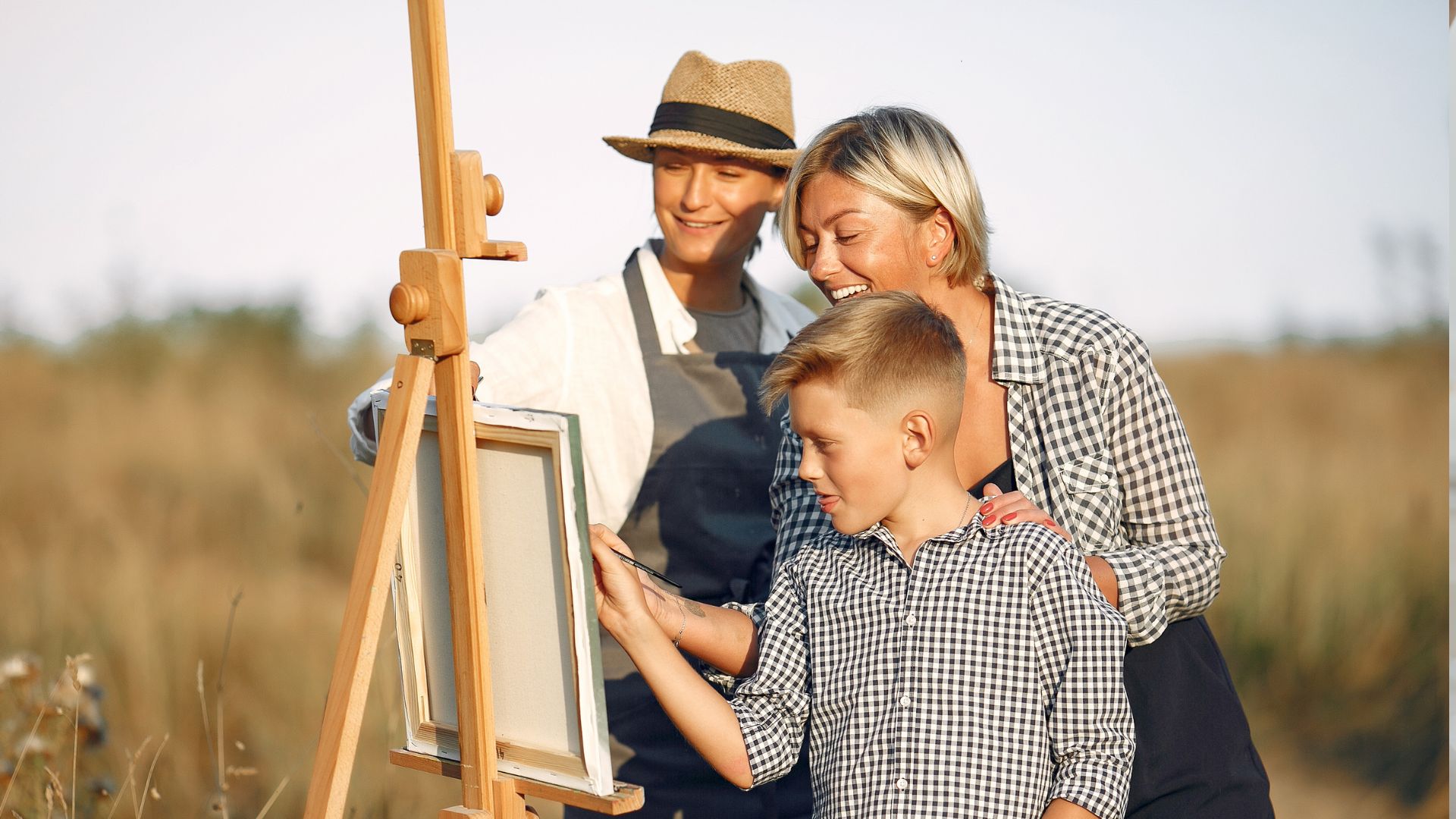 Happy people painting on canvas together