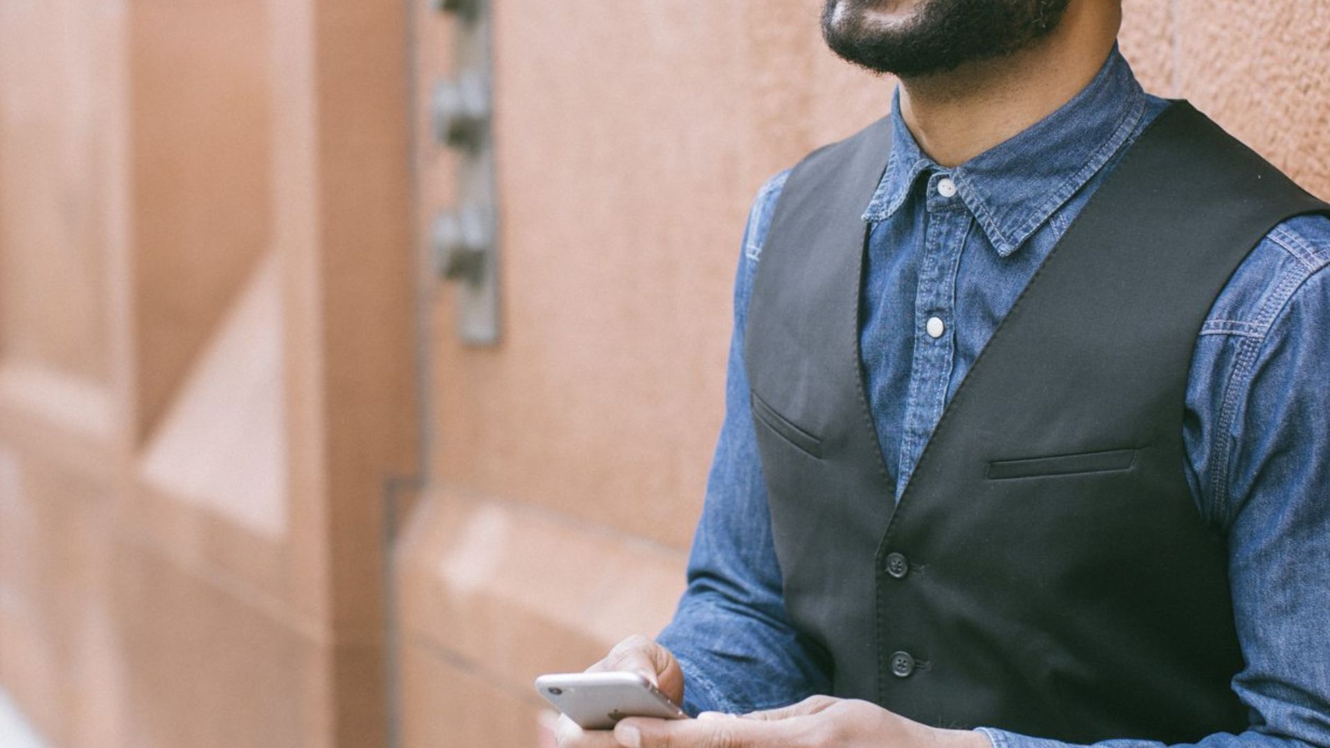 Man Wearing Black Vest and Blue Denim Shirt