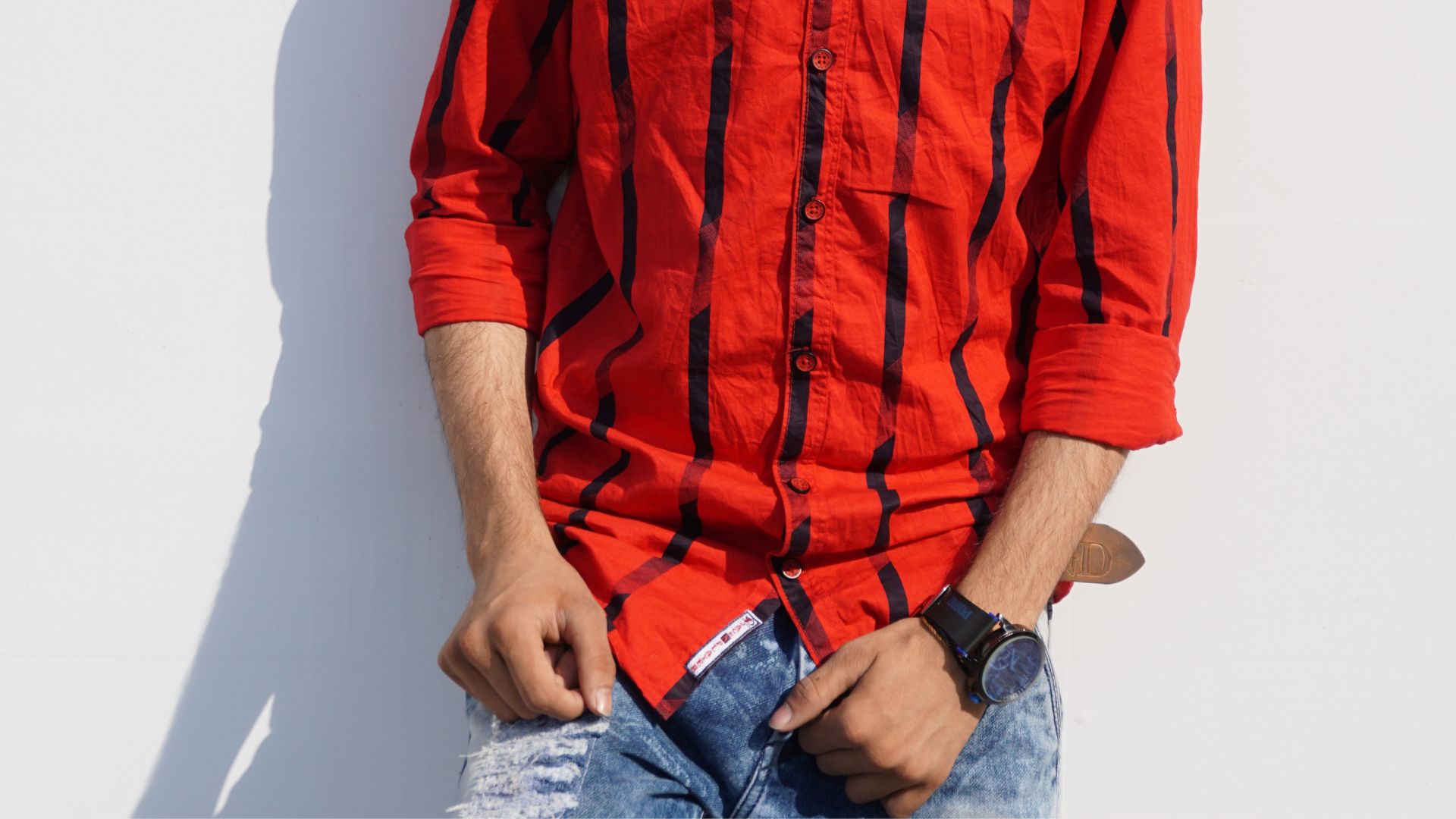 Man in Red and Black Striped Dress Shirt and Blue Denim Jeans