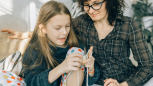 Mother Watching Her Daughter How To Crochet