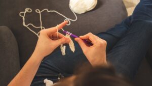 Person Holding A Crochet Hook