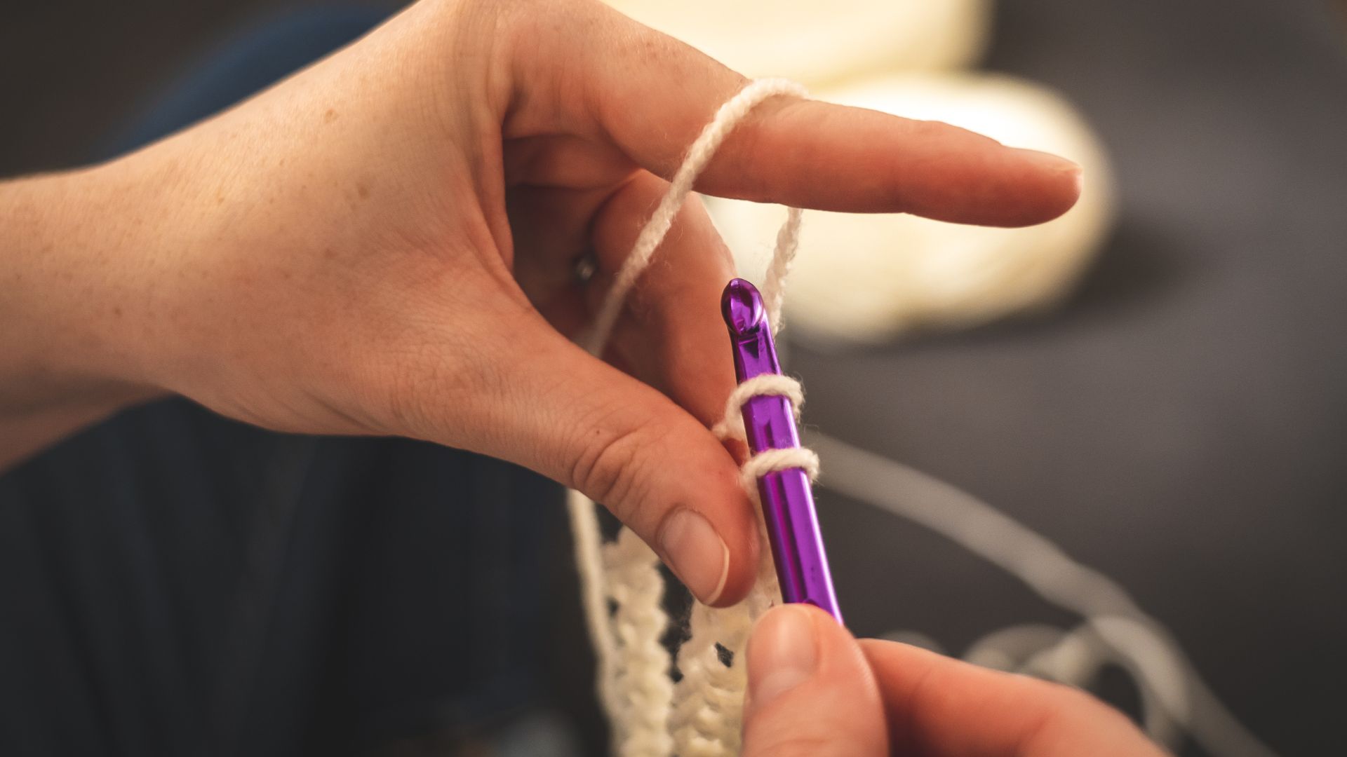 Person Holding Purple Crochet Hook ,,