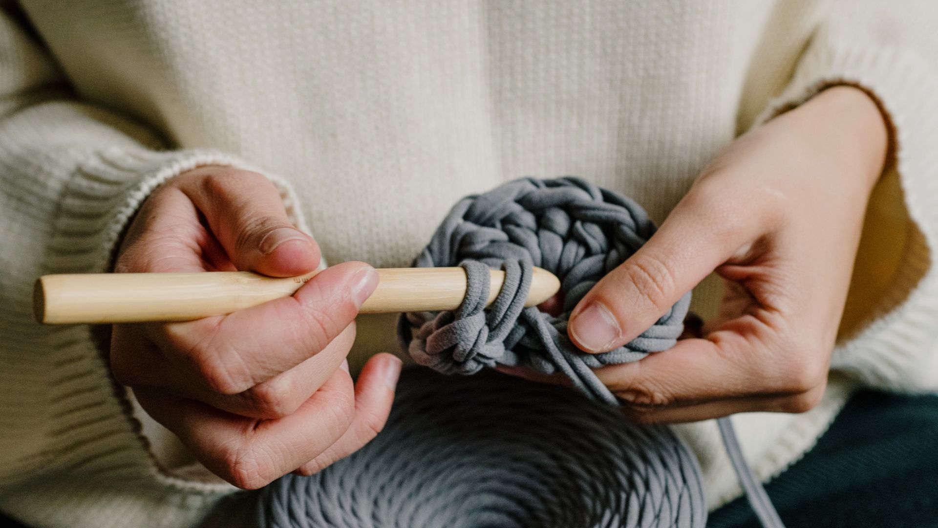 Person in Holding Gray Yarn