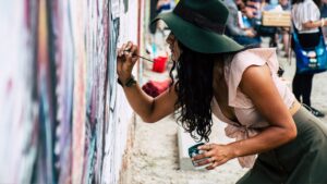 Photo of Woman Painting on Wall