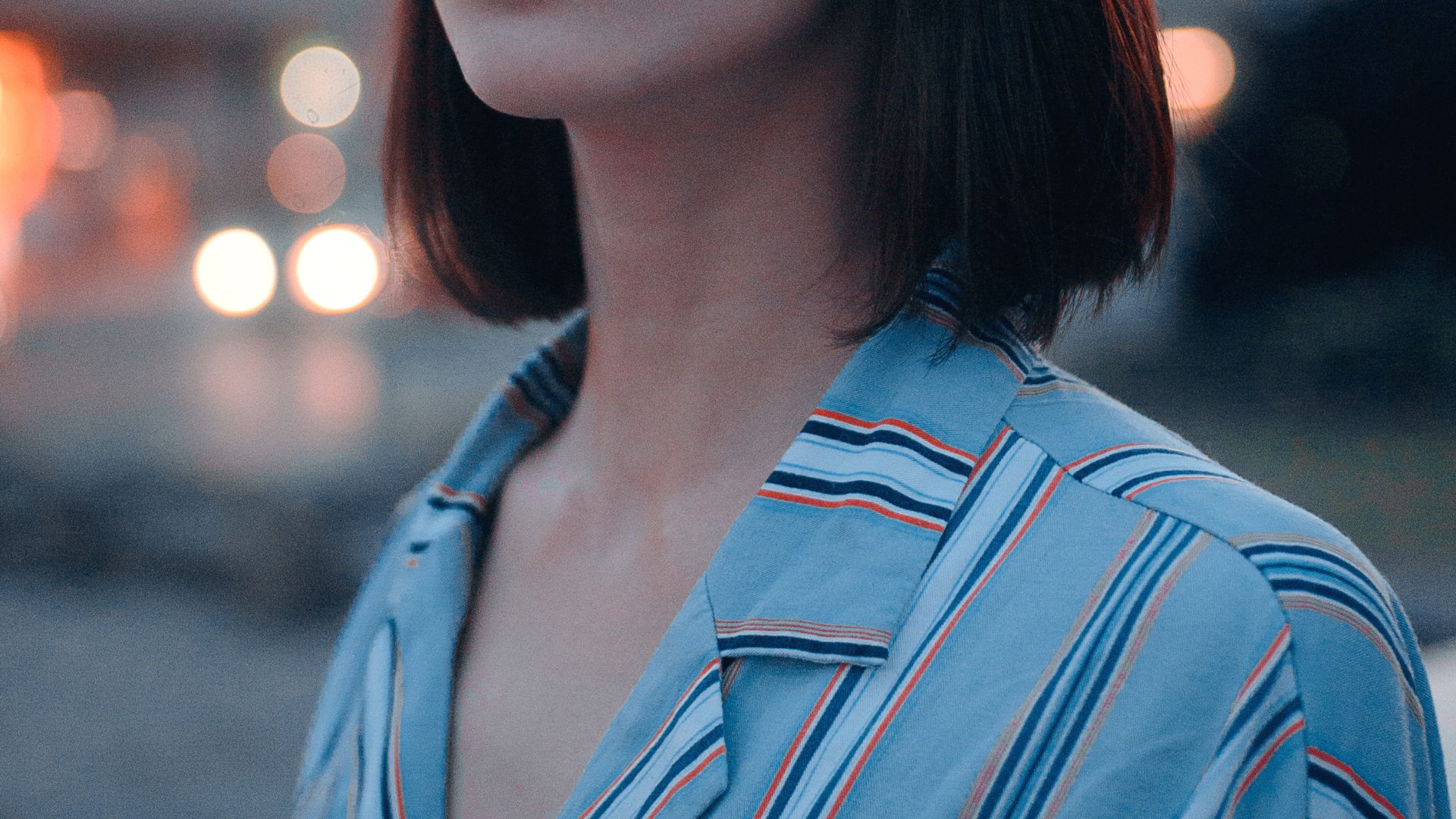 Shallow Focus Photo of Woman in Gray, White, and Brown Striped Button-up Shirt