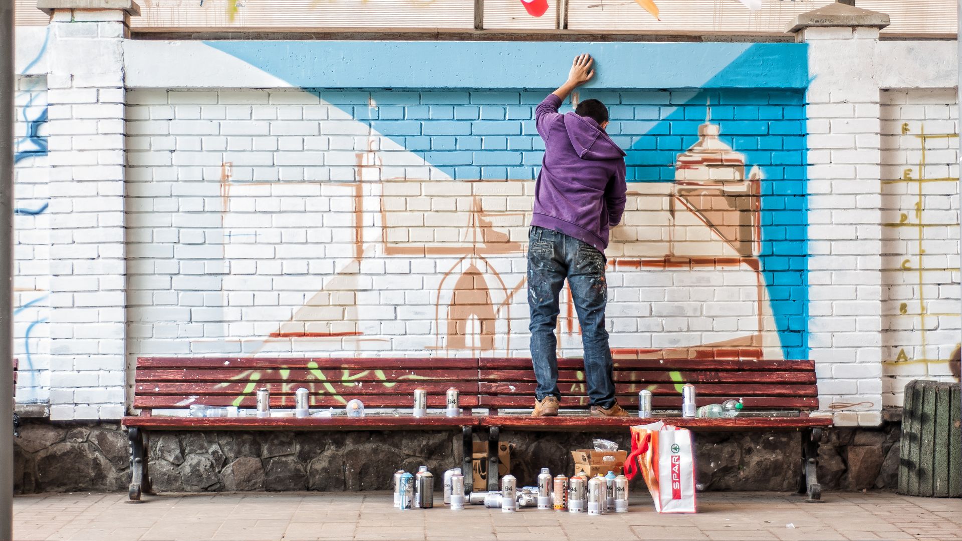 Street Artist Painting a Mural