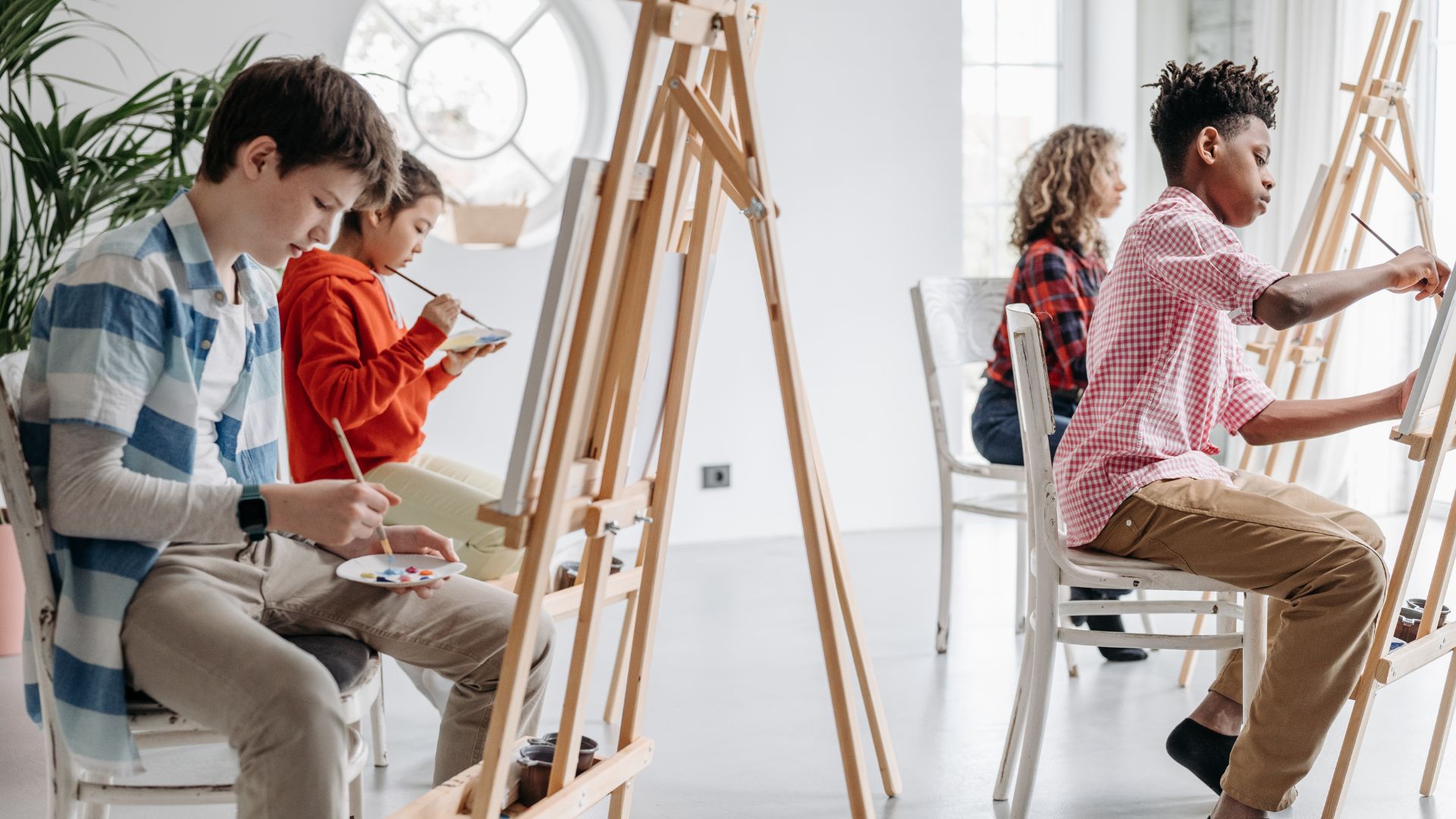 Students Seriously Painting on a Canvas