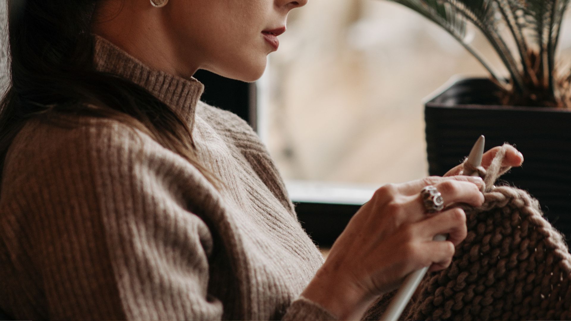 Woman Holding a Crochet and Knitting Needles