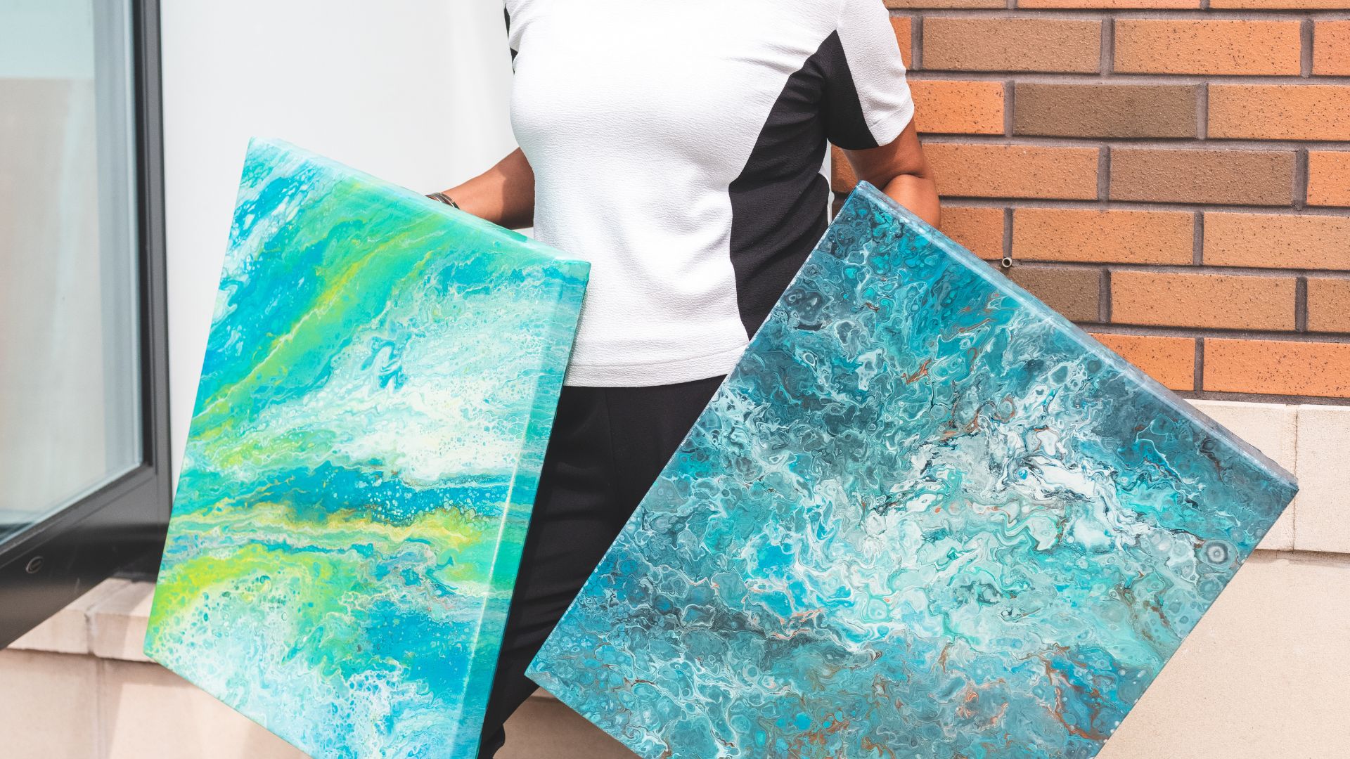 Woman Holds Two Abstract Canvas Paintings