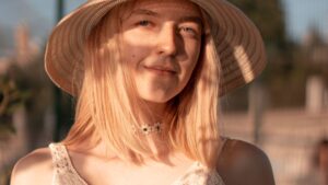 Woman in White Crochet Top Wearing Brown Straw Hat