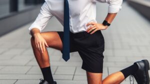 man wearing a dress shirt with shorts.